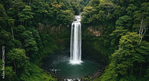 Breathtaking waterfall cascading into a pool surrounded by lush greenery