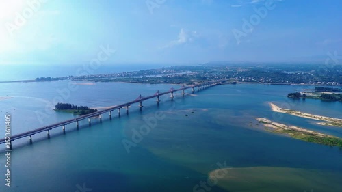 Wallpaper Mural Scenic drone footage of a bridge over clear blue water, sea, and dark green plants on the shore Torontodigital.ca