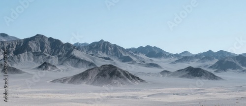 Desert Landscape with Distant Mountains and Hazy Horizon