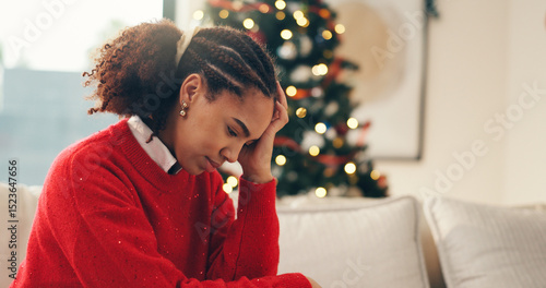 Sad, sofa and woman in home on Christmas with crying for depression, loneliness or hopeless. Mental health, holidays and person with tears and emotions for alone on xmas in living room at apartment.