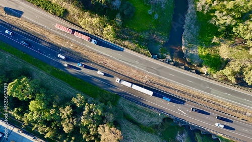Logan Motorway, Carole Park, South Brisbane, Queensland, Australia: Aerial Image of Multi-Lane Freeway, Vehicles, Trucks, Overpass, and Adjacent Greenbelt and Creek Infrastructure