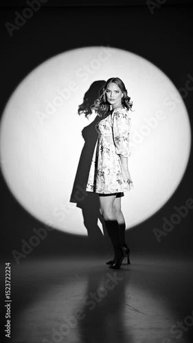 Beautiful model posing in studio, elegant movements to promote floral dess