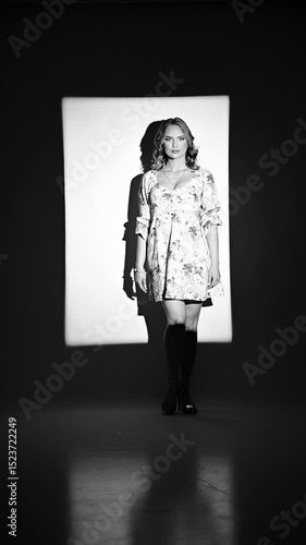 Beautiful model posing in studio, elegant movements to promote floral dess