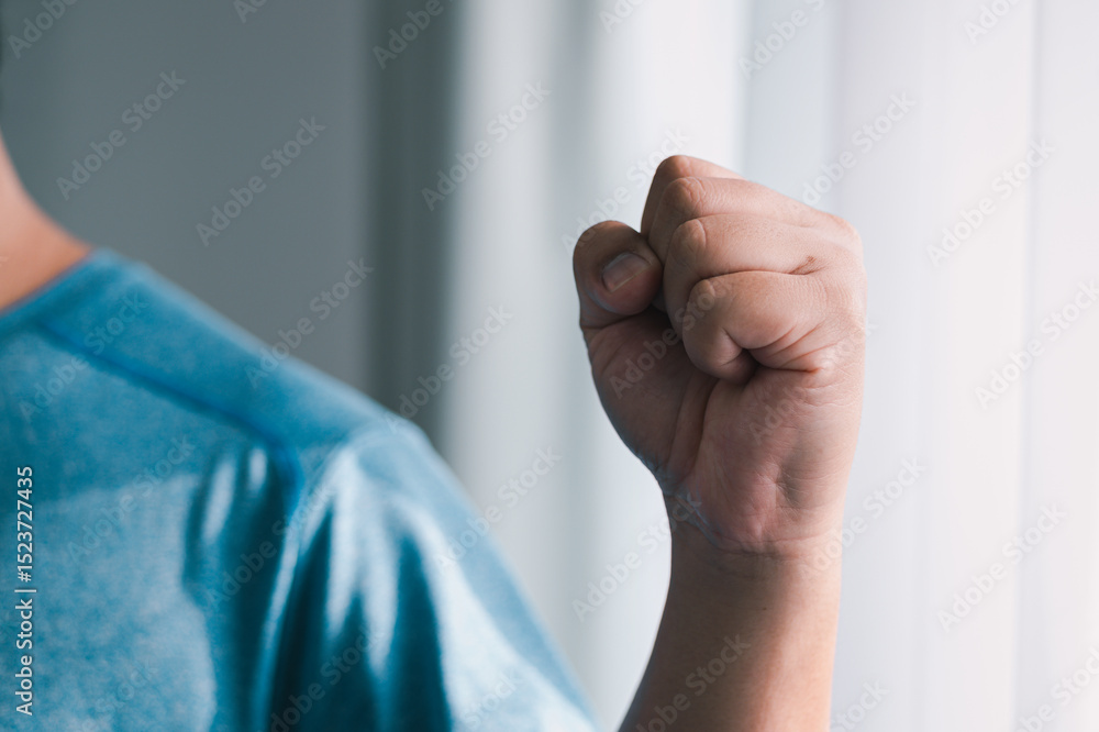 Naklejka premium Close-up of empowerment determined hand gesture signifying strength indoor setting