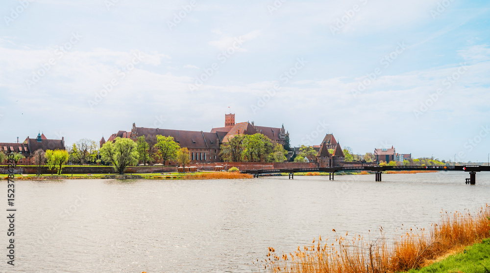 Fototapeta premium Teutonic Malbork castle in Pomerania region with Nogat river in Poland