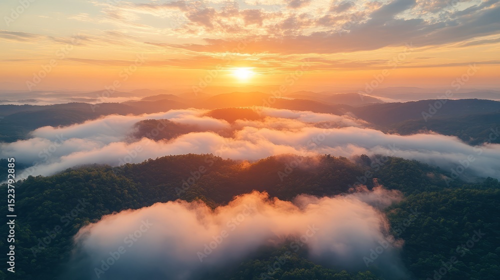 Fototapeta premium A breathtaking sunrise over rolling hills with layers of clouds and mist creating an ethereal landscape view.