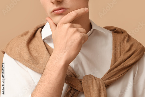 Young businessman on brown ...