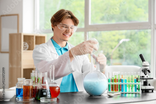 Male student in lab coat co...