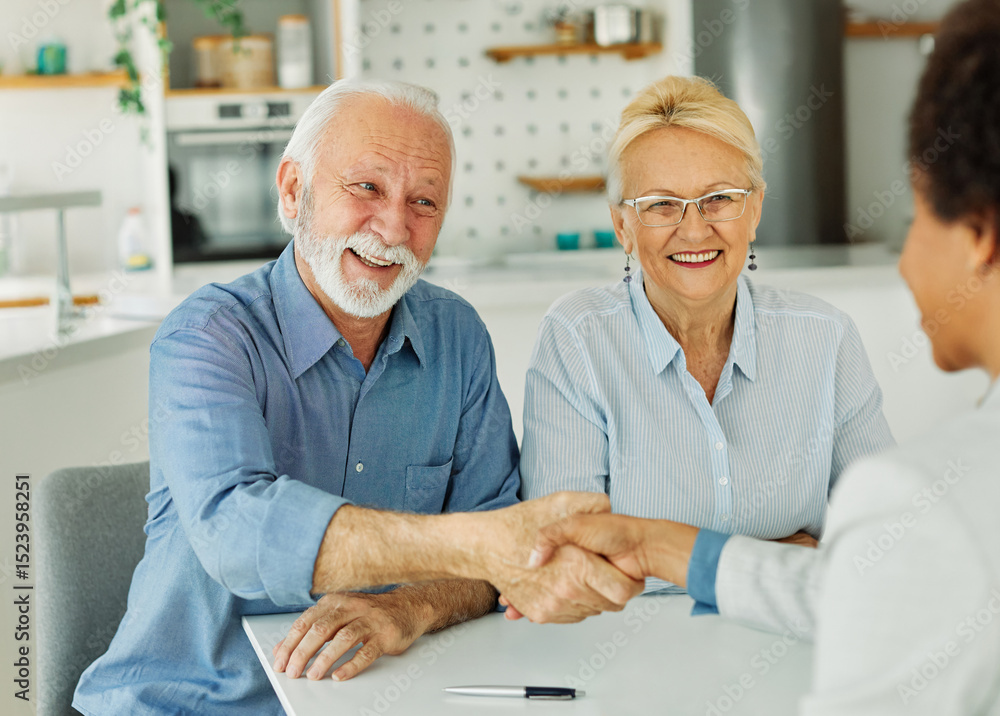 Obraz premium Portrait of a businessman or real estate agent or doctor shaking hands and signing a deal contract with senior couple in his office