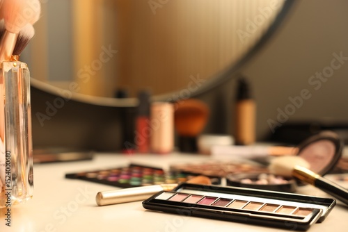 Wallpaper Mural Different makeup products and brushes on dressing table indoors, closeup Torontodigital.ca