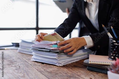 Fotografie Team of Business colleagues reviewing financial documents and calculating taxes