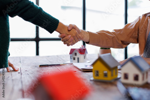 Wall Mural Handshake Real estate brokerage agent Deliver a sample of a model house to the c