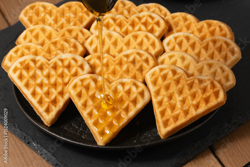 Heart-shaped waffles drizzled with honey