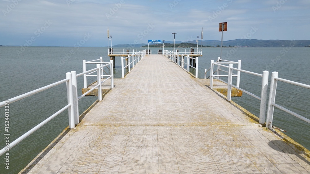 Obraz premium Europe, Italy, Umbria, drone view of Pontile Sant'arcangelo in Trasimeno lake - the landing stage for the ferries that take tourists to the larger and smaller islands - tourist attraction destination