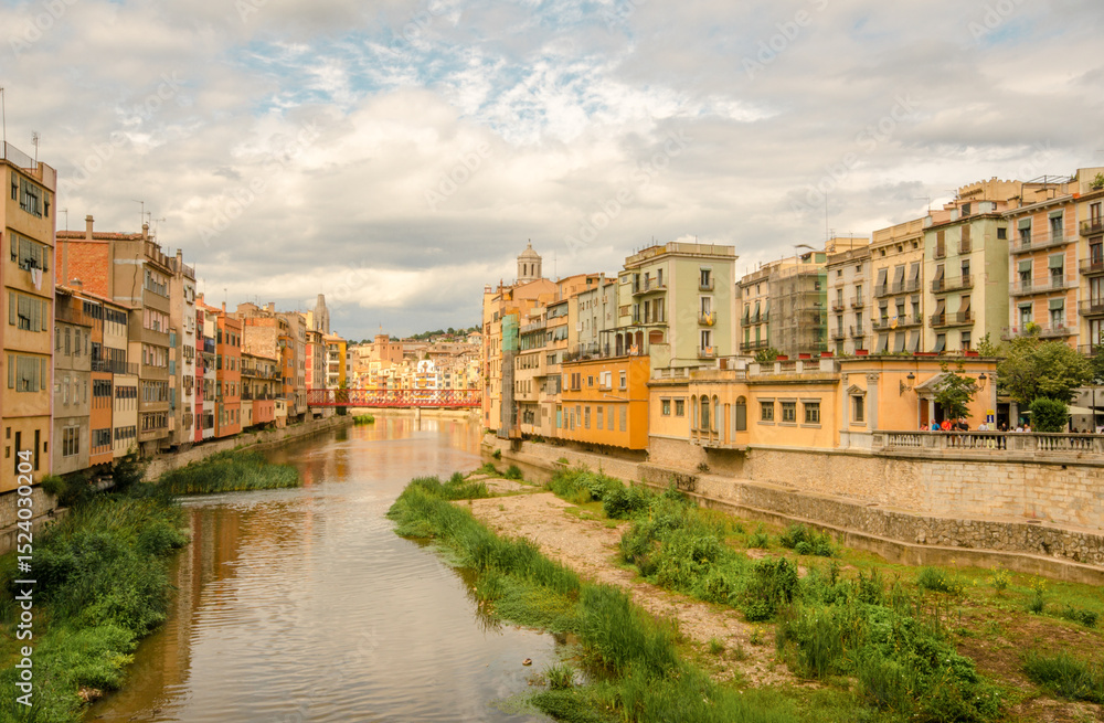 Fototapeta premium Spain - Girona city, day trip from Barcelona. Travel Costa Brava. Tuscany in Spain. Off the beaten path holidays. Colorful houses by river. Spanish cityscape view. Traditional picturesque south Europe