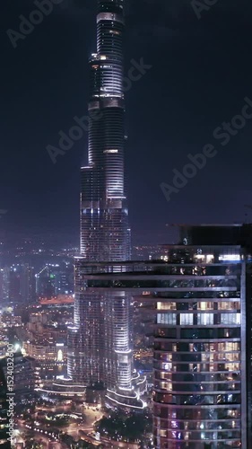 Night view of iconic skyscrapers and busy traffic on a major interchange in Downtown Dubai, UAE. Stunning skyline of a modern city, symbolizing business, finance, and urban development