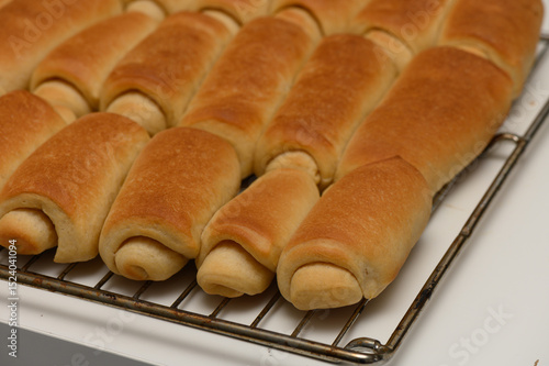 Принти на полотні Golden Parker House rolls resting on a wire rack, just out of the oven