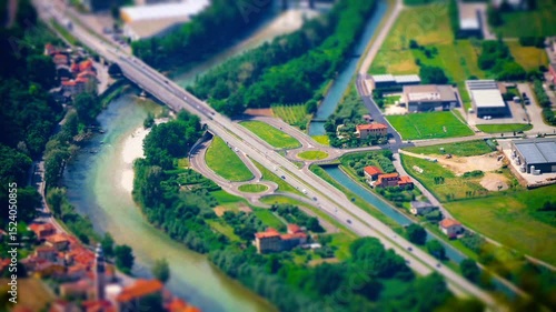 aerial view with miniature effect (tilt shift) of a road network with cars passing by