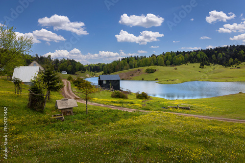Turkey's camping plateau Sultanpinar, people having picnic and wonderful sunset in the background and the sun reflecting on the lake