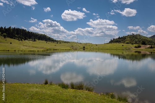 Turkey's camping plateau Sultanpinar, people having picnic and wonderful sunset in the background and the sun reflecting on the lake