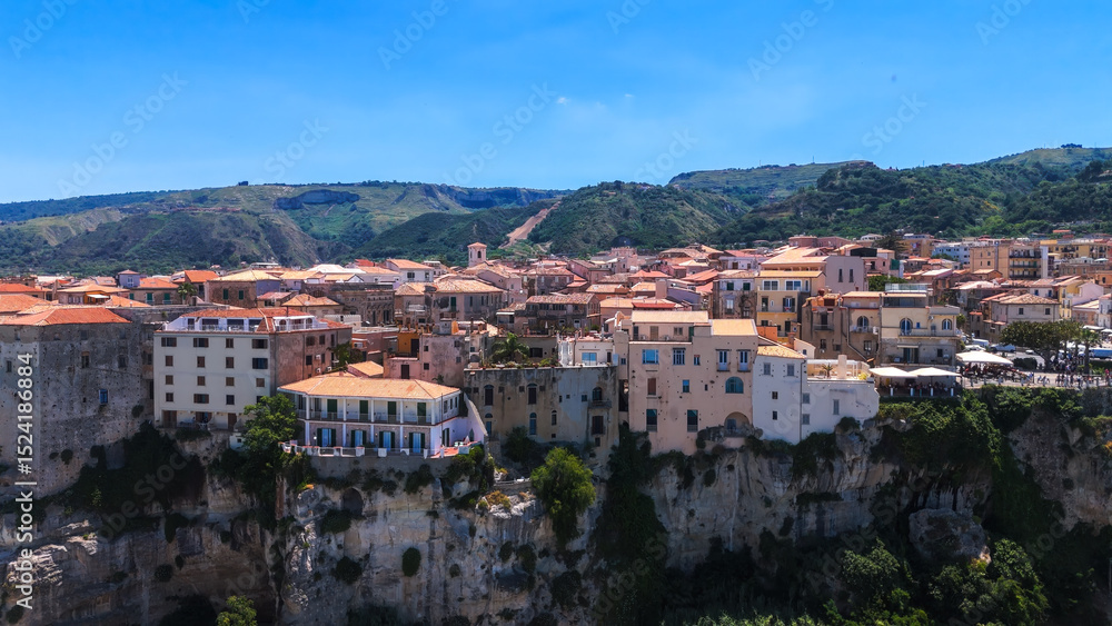 Obraz premium Aerial view of Tropea, a charming town perched on a cliff overlooking the Tyrrhenian Sea in Calabria, Southern Italy