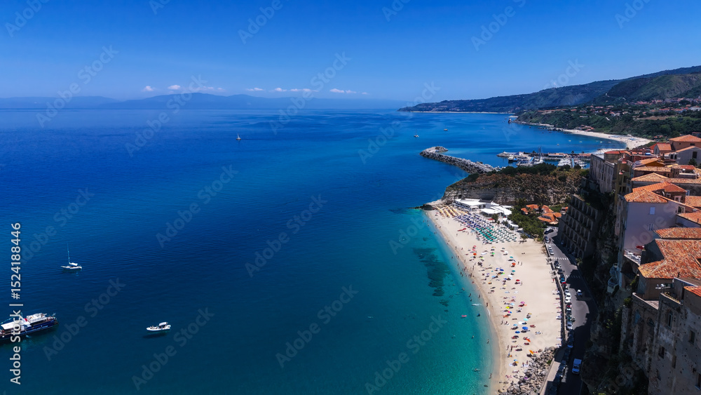 Obraz premium Aerial view of Tropea, a charming town perched on a cliff overlooking the beautiful turquoise waters of the Tyrrhenian Sea, Calabria, Southern Italy