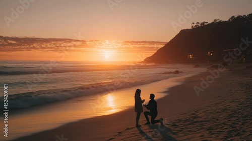 A man kneeling on the beach during sunset, proposing to his partner with a ring.