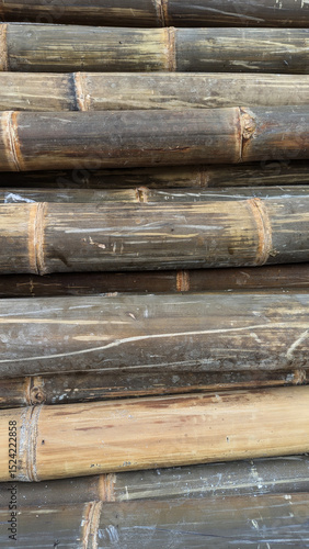 Stacked bamboo poles with natural texture and earthy colors, creating an organic