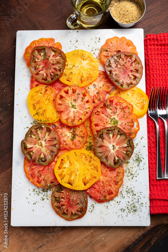 Farm fresh Healthy organic seasoned Heirloom tomato slices on a platter, healthy eating concept