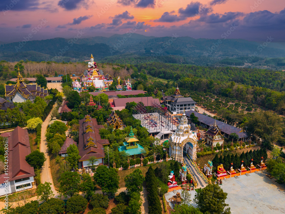 Fototapeta premium Aerial view of wat sang kaew phothiyan temple and scenic landscape at sunset in chiang mai, Thailand