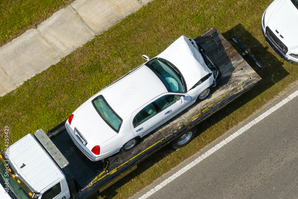 custom made wallpaper toronto digitalCar crash site with tow truck loading destroyed vehicle on American street. Emergency services personnel responding to accident in Florida, USA
