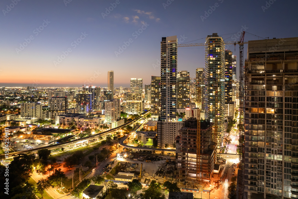 Naklejka premium Downtown district of Miami Brickell in Florida, USA at sunset. Urban landscape of high-rise buildings in modern American megapolis