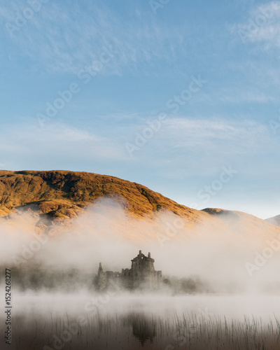 Castle shrouded in mist on a crisp sunny morning