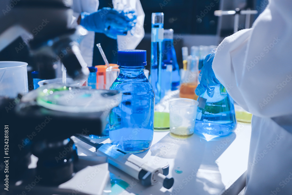 Scientist pipetting medical samples into microplate in laboratory Scientist pipetting medical samples into microplate in laboratory