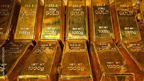 Stack of gold bars with engraved weight and purity marks arranged in rows. Wealth, asset and financial reserve concept.