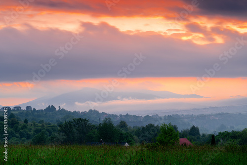 Fototapeta Naklejka Na Ścianę i Meble -  Sunset in the countryside with a view of the mountains, Beskids, Poland.	
