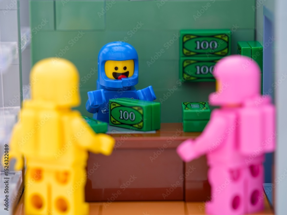 Obraz premium Tambov, Russian Federation - May 26, 2025 Three Lego astronaut minifigures standing near table with money in office