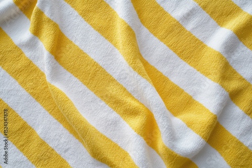Yellow and White Striped Beach Towel, Yellow and white striped beach towel laid out on sand, perfect for sunbathing or relaxing by the water