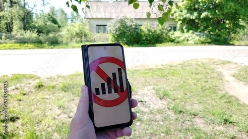 A man in the summer with a phone that has no signal