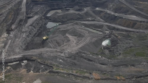 Aerial View of an Open Pit Coal Mine with Excavating Equipment and Earthmoving Work. Industrial Landscape of Mineral Extraction.
