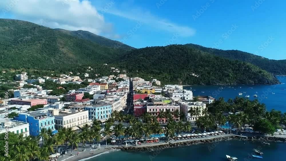 Colorful Coastal Town Nestled by Lush Green Hills and Blue Waters Colorful Coastal Town Nestled by Lush Green Hills and Blue Waters