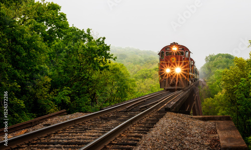 Red train engine Arkansas Missouri railroad on bridge 