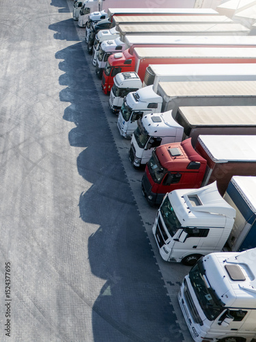 Wallpaper Mural Aerial view of a large truck parking lot at a logistics hub, with multiple commercial semi trucks parked in organized rows Torontodigital.ca