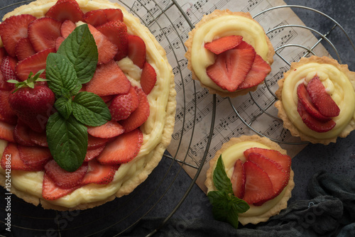 Homemade Strawberry Tart with Cream and Mint on Rustic Background