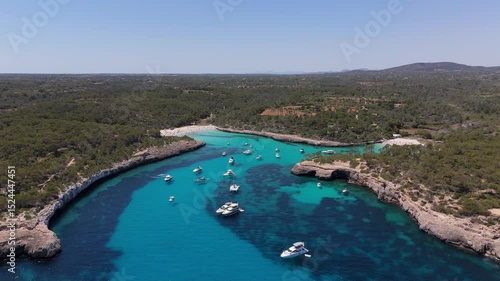 Wallpaper Mural Stunning aerial view of Cala Mondragó beach with anchored boats and crystal-clear Mediterranean waters. Concept of summer, beach, Mediterranean Sea. Torontodigital.ca
