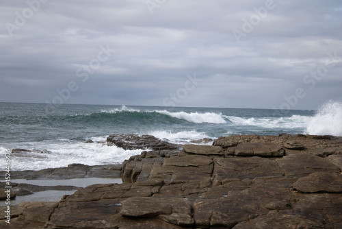 Various waves from the ocean crashing onto the rocks on the south coast of South Africa, located at Orange Rocks in Uvongo in Margate