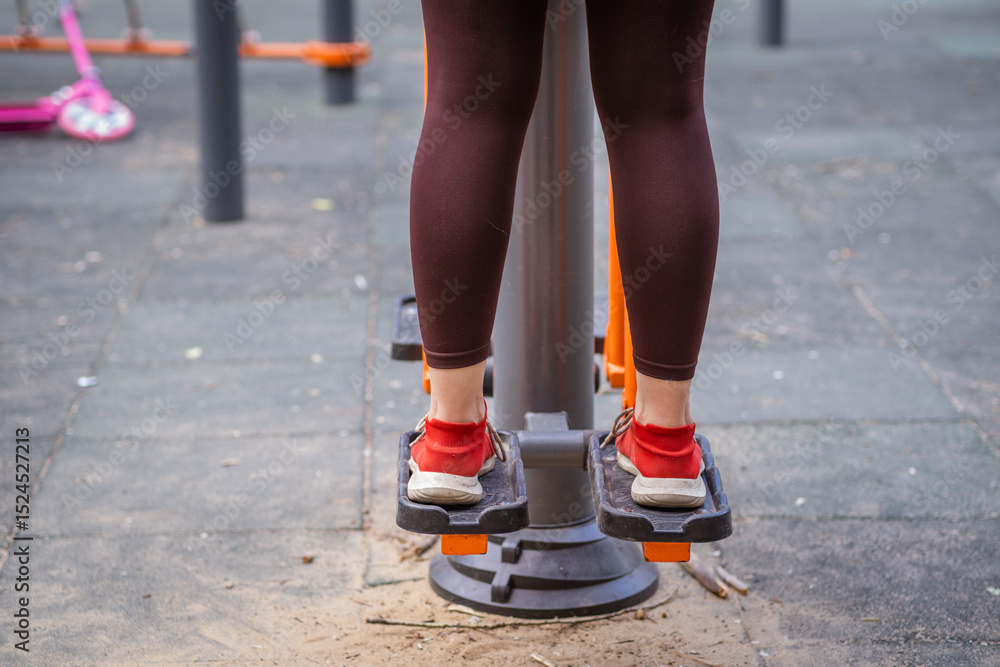 Woman Working Out on Outdoor Exercise Equipment in the Park Woman Working Out on Outdoor Exercise Equipment in the Park