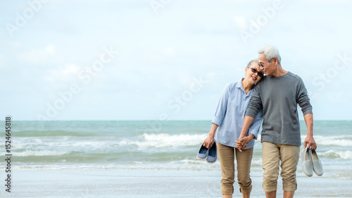 Asian Lifestyle senior couple walking chill on the beach happy in love romantic and relax time after retirement. People tourism elderly family travel leisure and activity after retirement