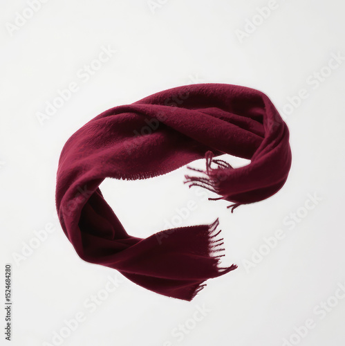 Burgundy Scarf Floating Gracefully in Air Against White Background, Elegant Fabric Movement for Fashion, Textile, or Minimal Design Concepts