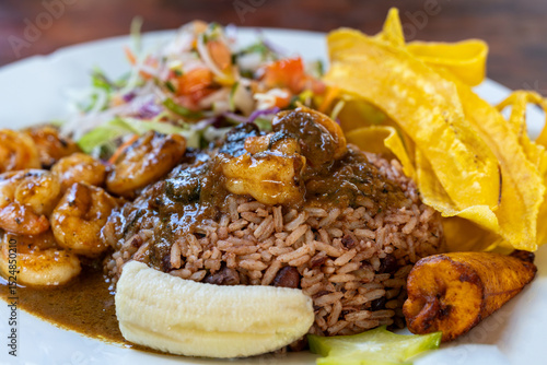 Traditional Caribbean dish of rice and beans with shrimp, fried plantains and fresh salad in Puerto Viejo, Costa Rica
